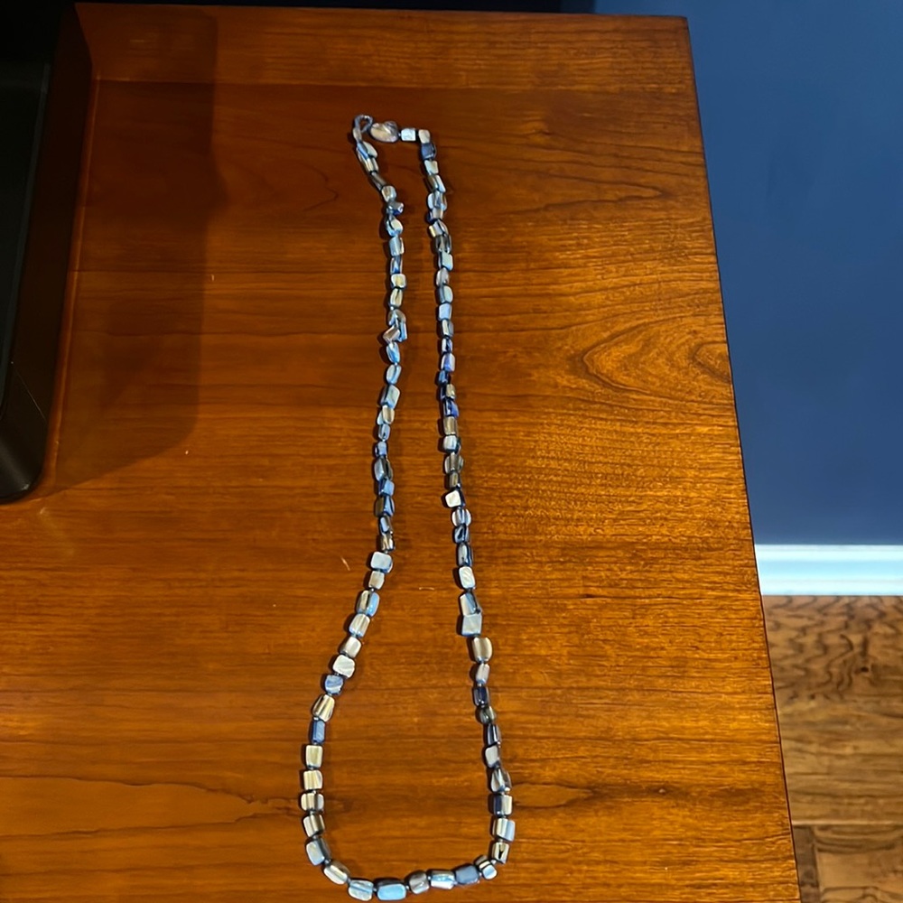 35 inches in length, Blue beaded necklace with a toggle style closure